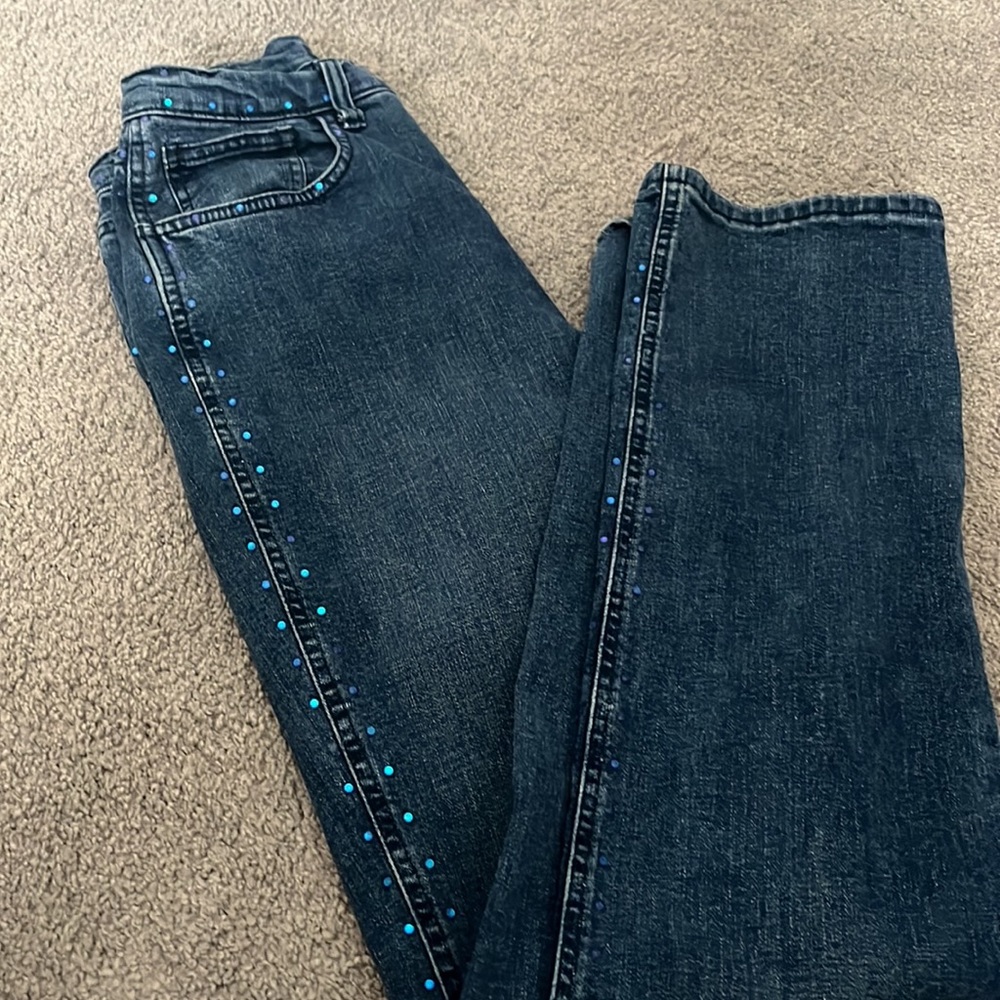 Hamnett jeans with blue stud accent on waist and down leg.